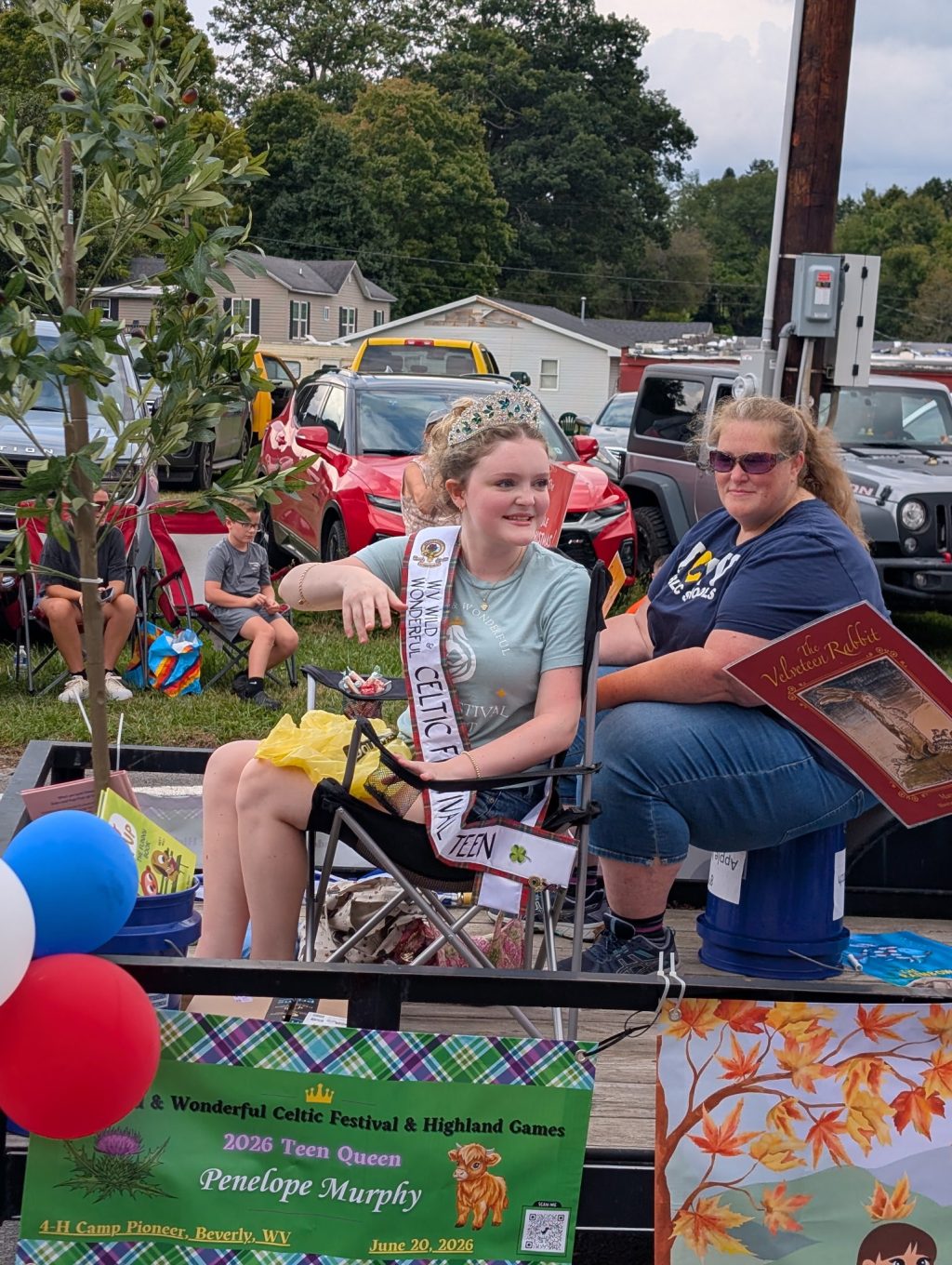 2026 Celtic Festival Teen Queen Penelope Murphy throwing candy from the NCLA Float at the Potato Festival with NCLA President Jennifer Davis sitting behind.